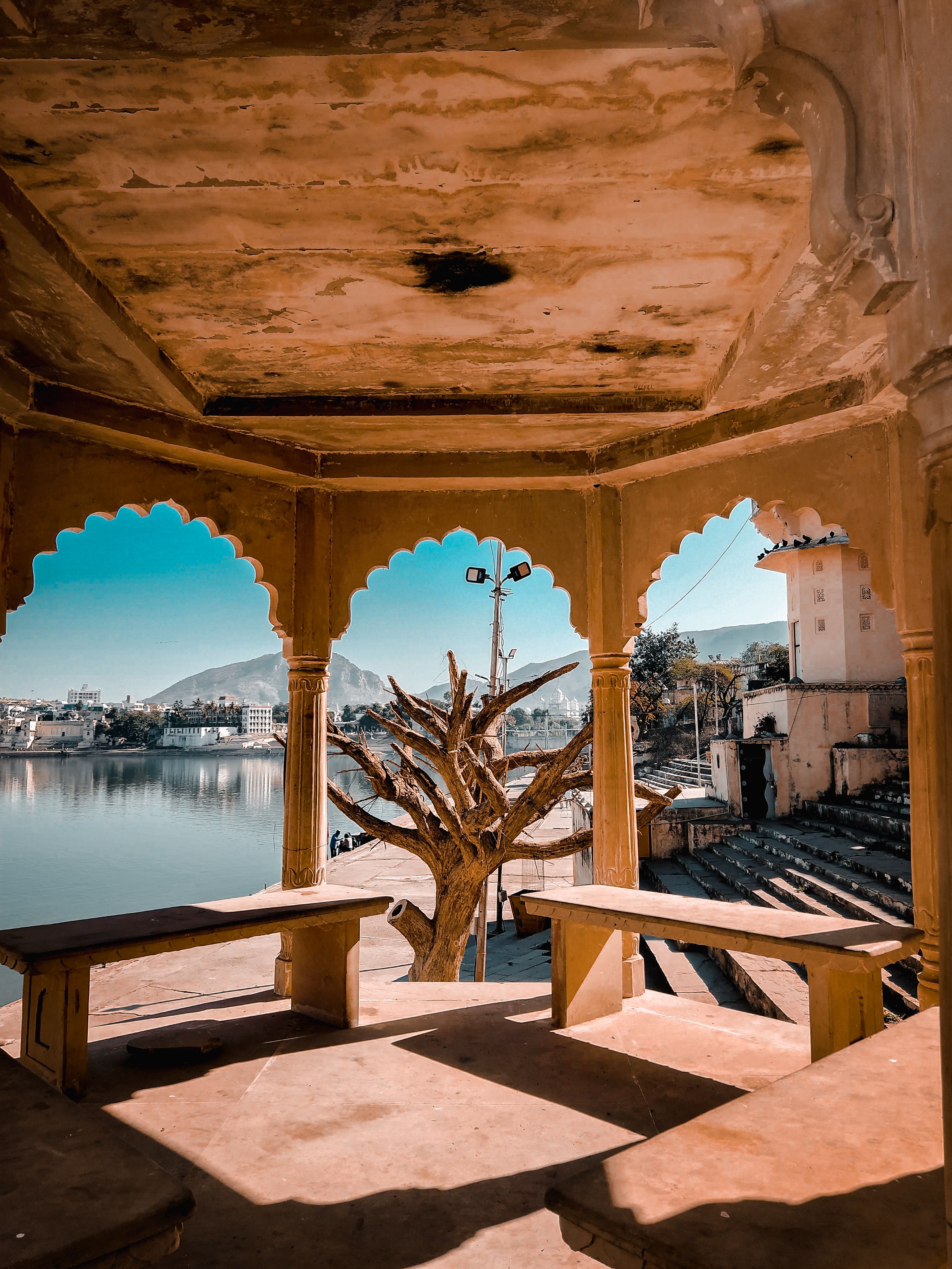 White ghat steps descending into Pushkar holy lake waters